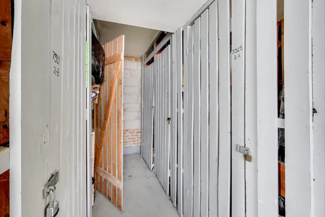 a view of a hallway with wooden floor and entryway
