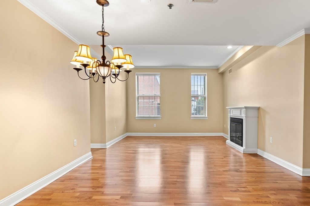 17 Central Street, Unit 9 Salem, MA 01970 - Photo 11 of 27 a view of a livingroom with a chandelier wooden floor chandelier and a window