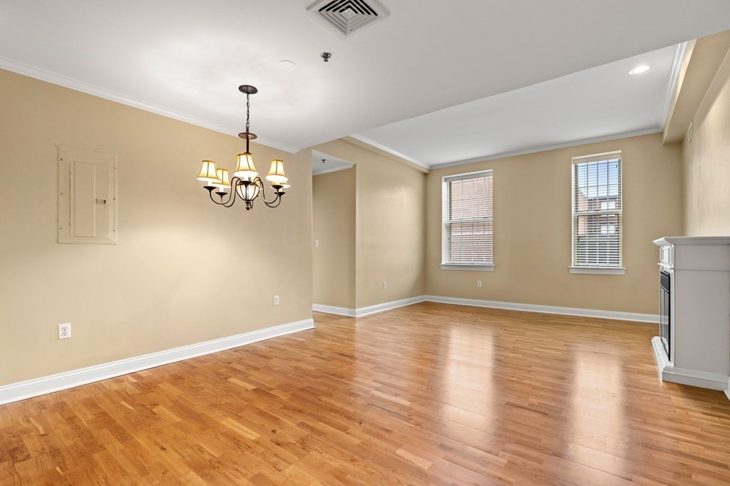 17 Central Street, Unit 9 Salem, MA 01970 - Photo 12 of 27 a view of an empty room with a window and wooden floor