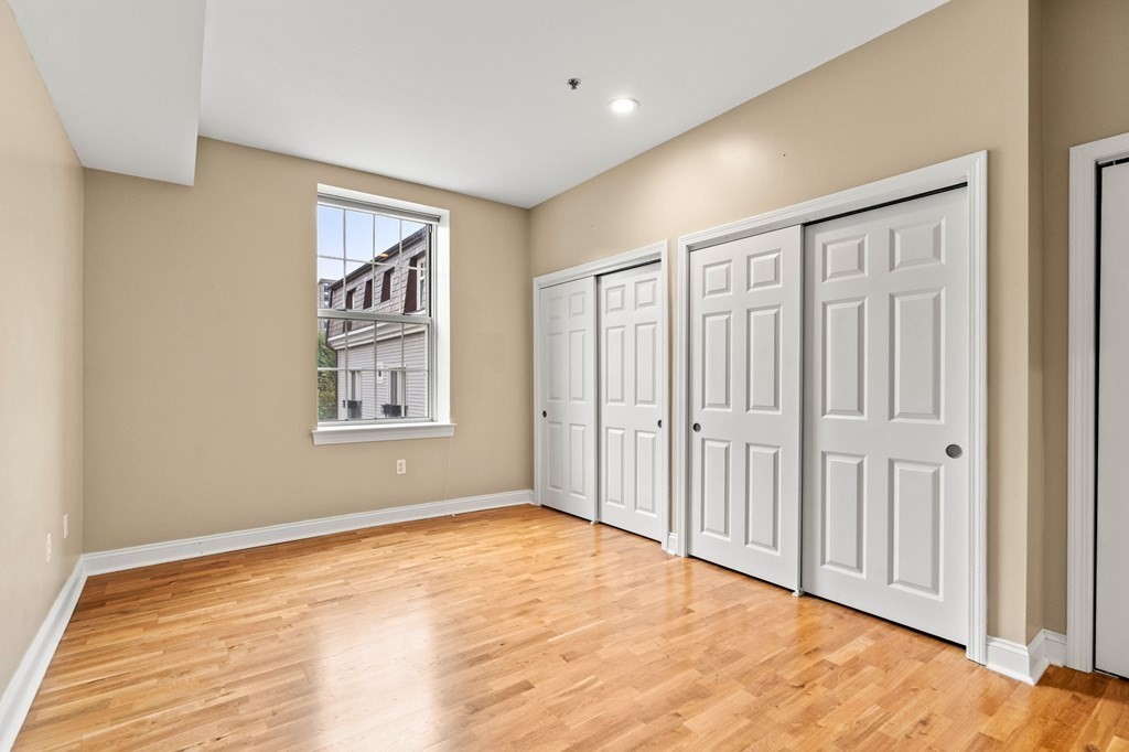17 Central Street, Unit 9 Salem, MA 01970 - Photo 14 of 27 a view of an empty room with wooden floor and a window