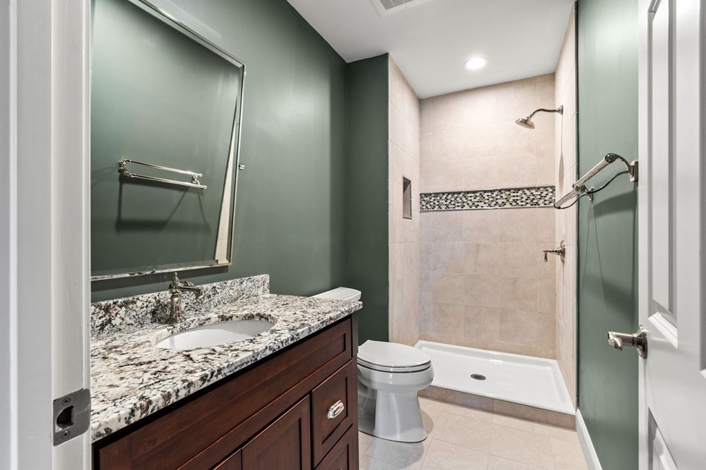 17 Central Street, Unit 9 Salem, MA 01970 - Photo 17 of 27 a bathroom with a granite countertop sink toilet and shower