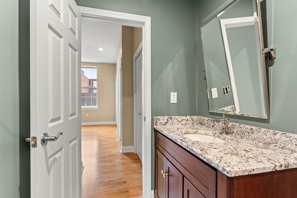 17 Central Street, Unit 9 Salem, MA 01970 - Photo 18 of 27 a bathroom with a granite countertop sink and a mirror