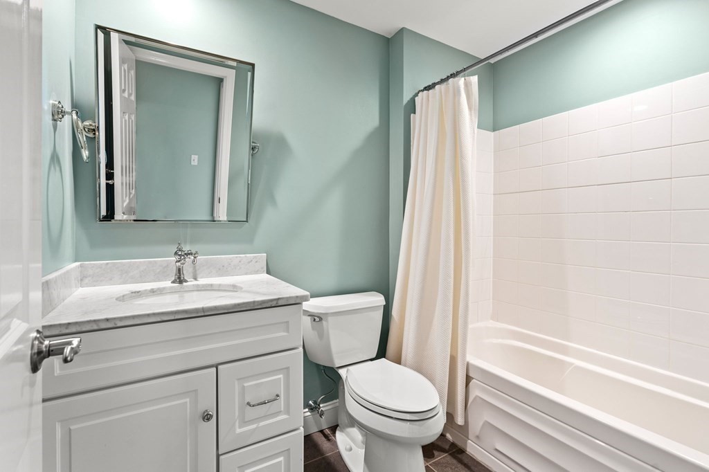 17 Central Street, Unit 9 Salem, MA 01970 - Photo 22 of 27 a bathroom with a sink a toilet and a mirror