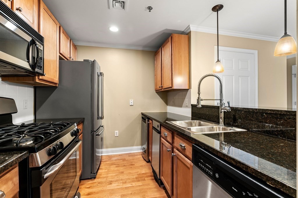 17 Central Street, Unit 9 Salem, MA 01970 - Photo 6 of 27 a kitchen with stainless steel appliances granite countertop a stove a sink and a microwave