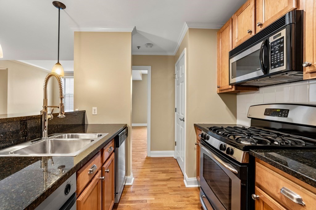 17 Central Street, Unit 9 Salem, MA 01970 - Photo 7 of 27 a kitchen with stainless steel appliances granite countertop a sink stove and refrigerator
