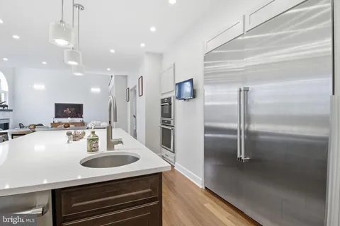 a kitchen with a sink stainless steel appliances and cabinets