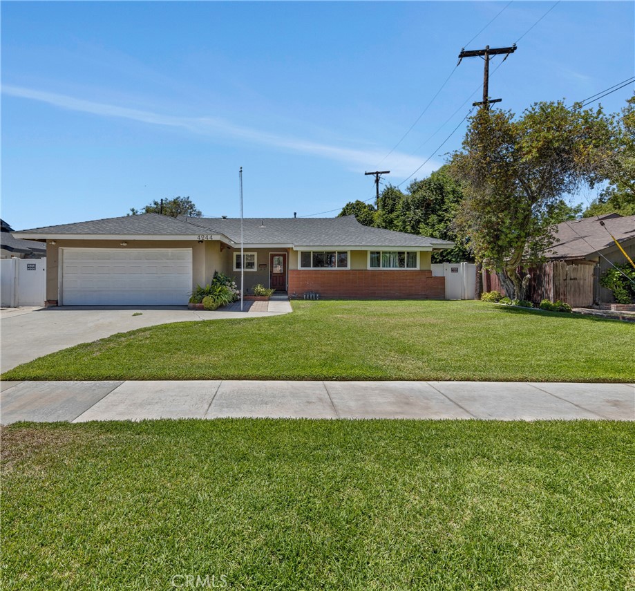 4244 Monroe Street Riverside, CA 92503 - Photo 1 of 1 a view of a house next to a yard