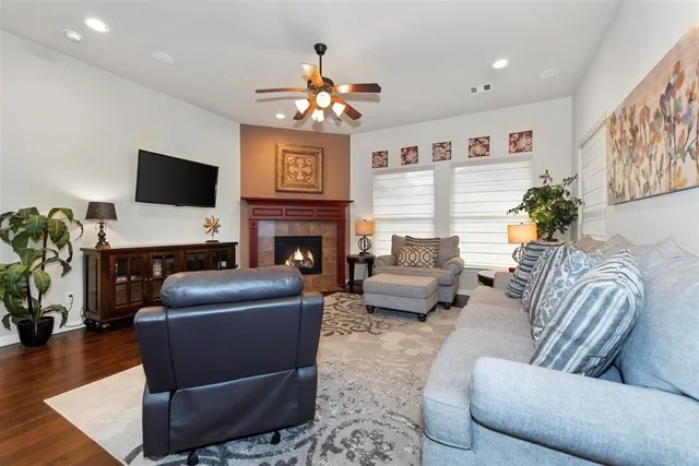 a living room with furniture a fireplace and a flat screen tv