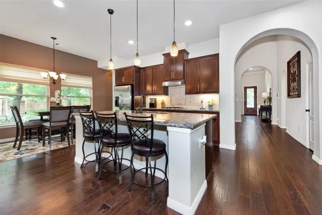 a large kitchen with a table and chairs in it