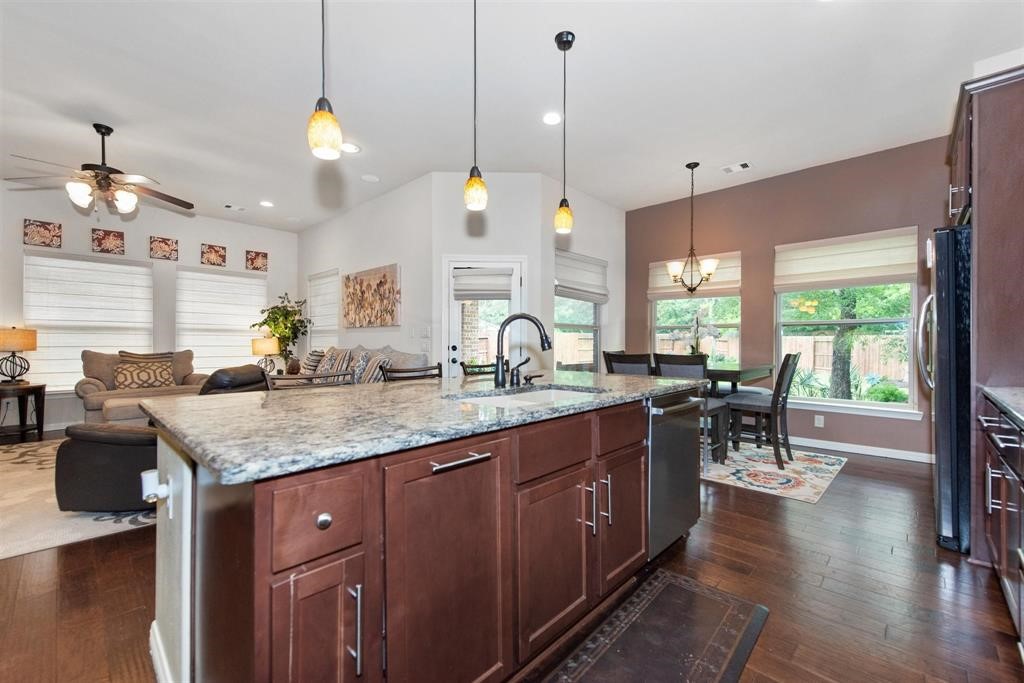8323 Floating Heart Court Conroe, TX 77385 - Photo 18 of 43 a kitchen with counter space dining table and chairs