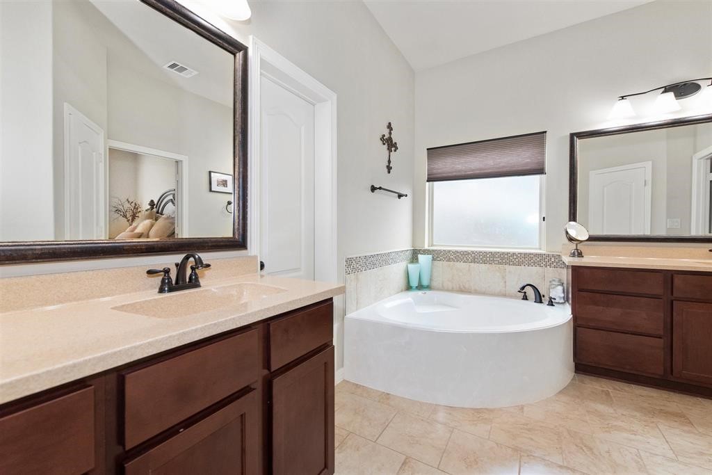8323 Floating Heart Court Conroe, TX 77385 - Photo 23 of 43 a bathroom with a tub a sink and mirror