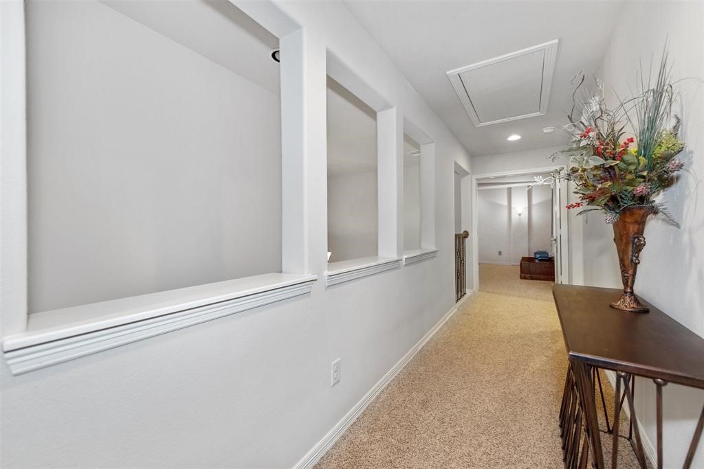 8323 Floating Heart Court Conroe, TX 77385 - Photo 32 of 43 a view of a hallway with furniture and a potted plant