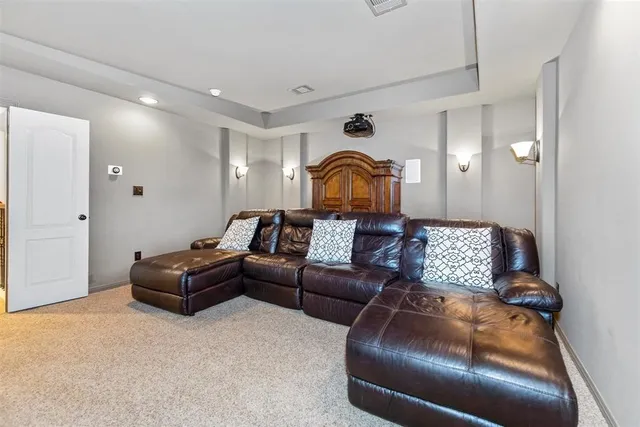 a living room with furniture and a mirror