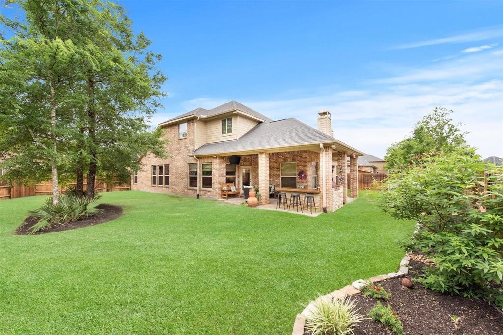 8323 Floating Heart Court Conroe, TX 77385 - Photo 40 of 43 a front view of a house with garden