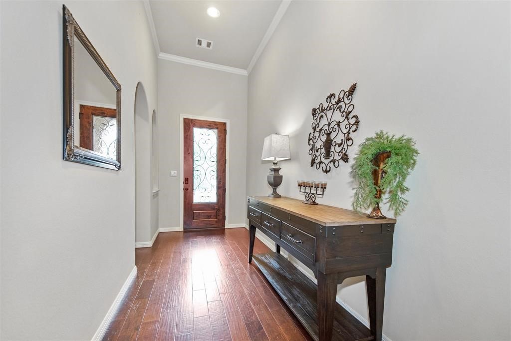 8323 Floating Heart Court Conroe, TX 77385 - Photo 6 of 43 a room with painting on the wall and a potted plant