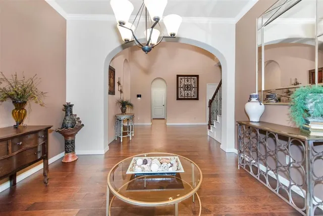 a view of a livingroom with furniture wooden floor and a chandelier