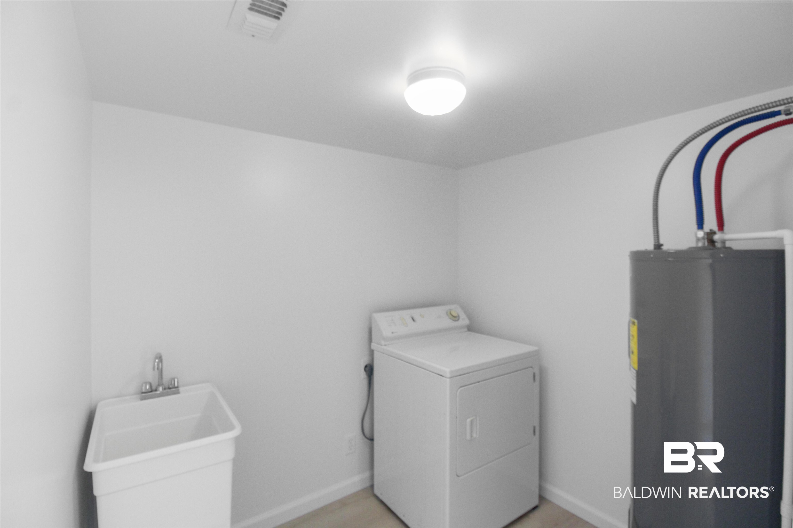 17622 Brewer Road Foley, AL 36535 - Photo 9 of 26 Laundry room featuring washer / dryer, electric water heater, and light wood finished floors