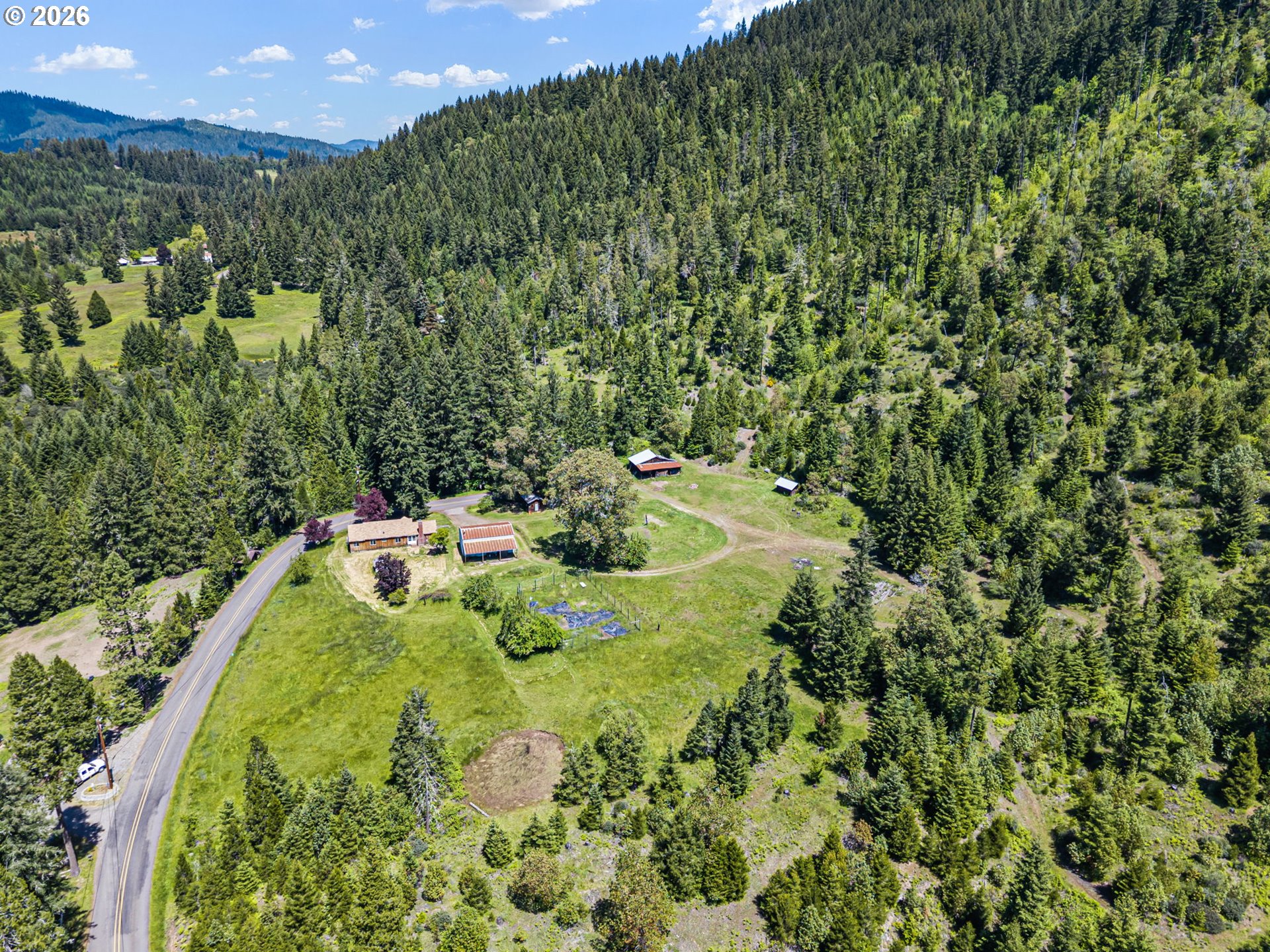77521 Brock Road Oakridge, OR 97463 - Photo 34 of 48 a backyard of a house with lots of green space and garden