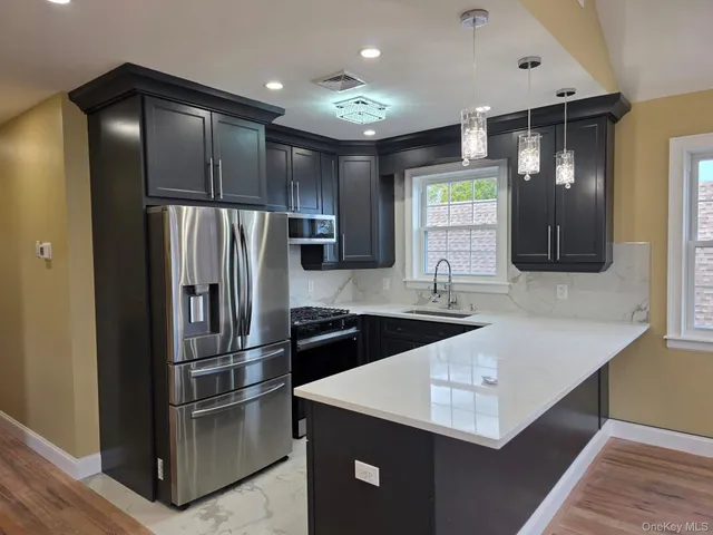 a kitchen with stainless steel appliances a refrigerator and a sink