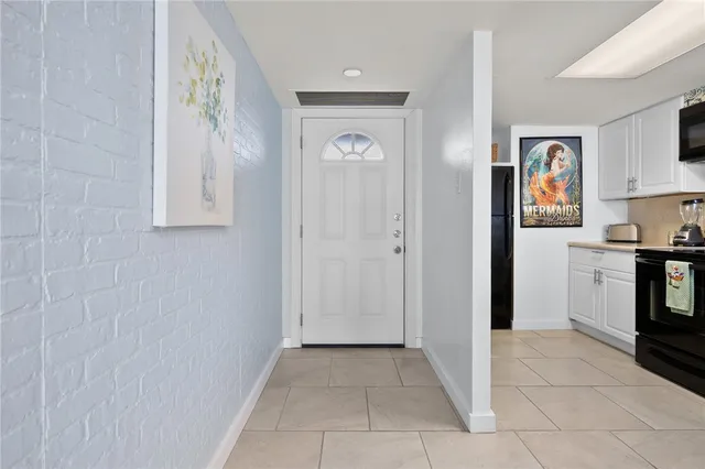a view of a hallway to rooms and stairs