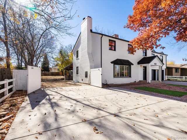 a front view of a house with a tree