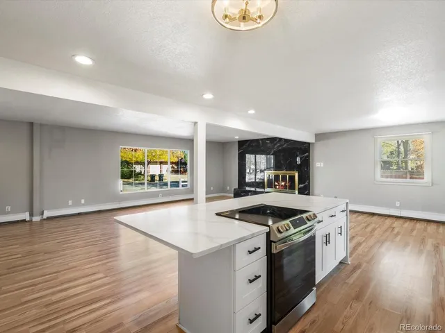 a kitchen that has a sink and a stove top oven