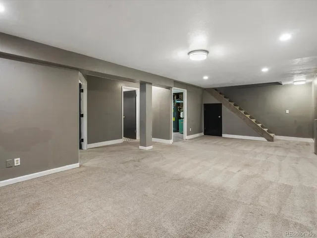 an empty room with closet and mirrors