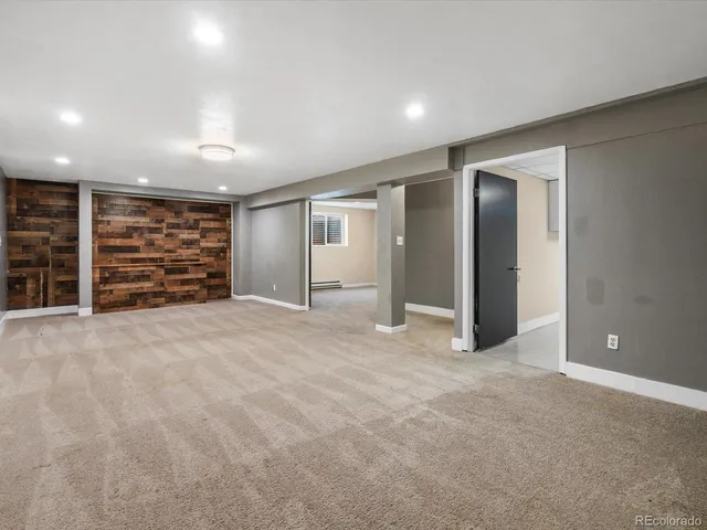 a view of an empty room with furniture and storage