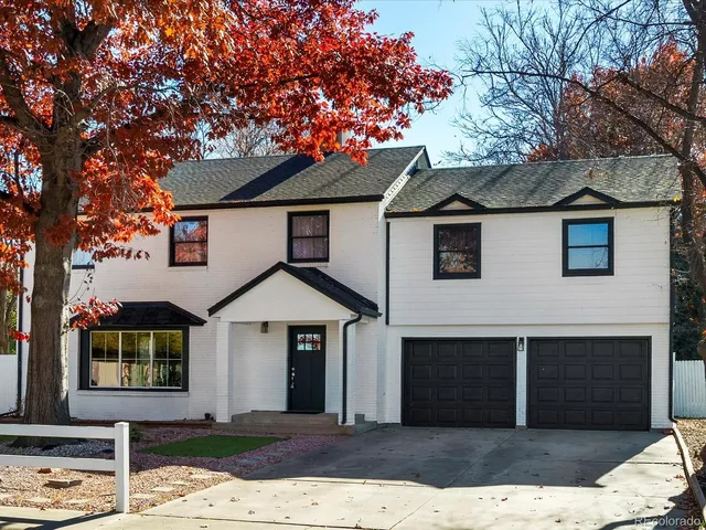 a front view of a house with a tree