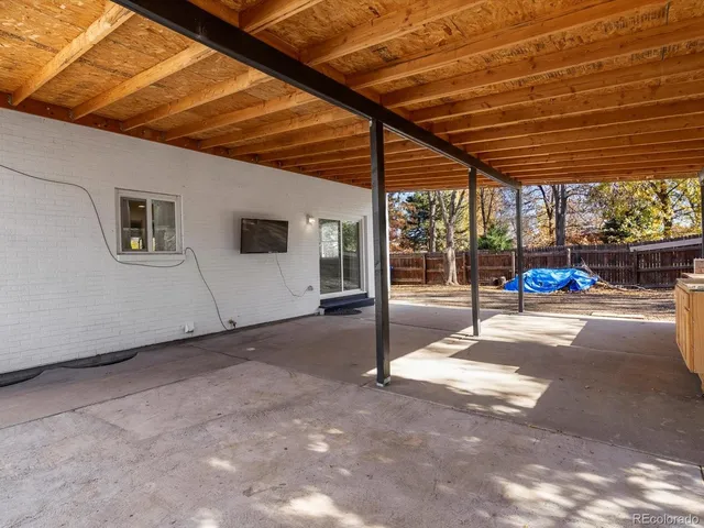 a front view of a house with a tree