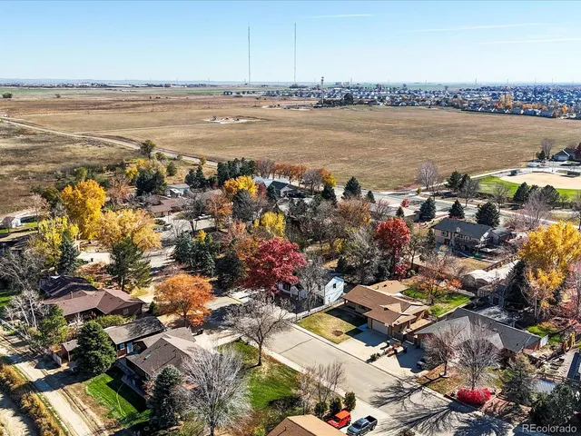 an aerial view of a residential houses with outdoor space