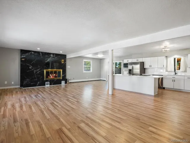 a view of a living room kitchen and a sink