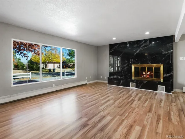 a view of livingroom with furniture flat screen tv and floor to ceiling window