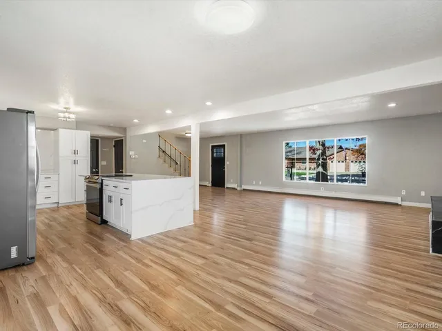 a view of kitchen and hall with wooden floor