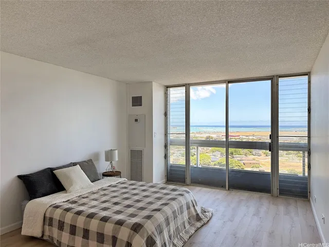 a bedroom with a large bed and a large window
