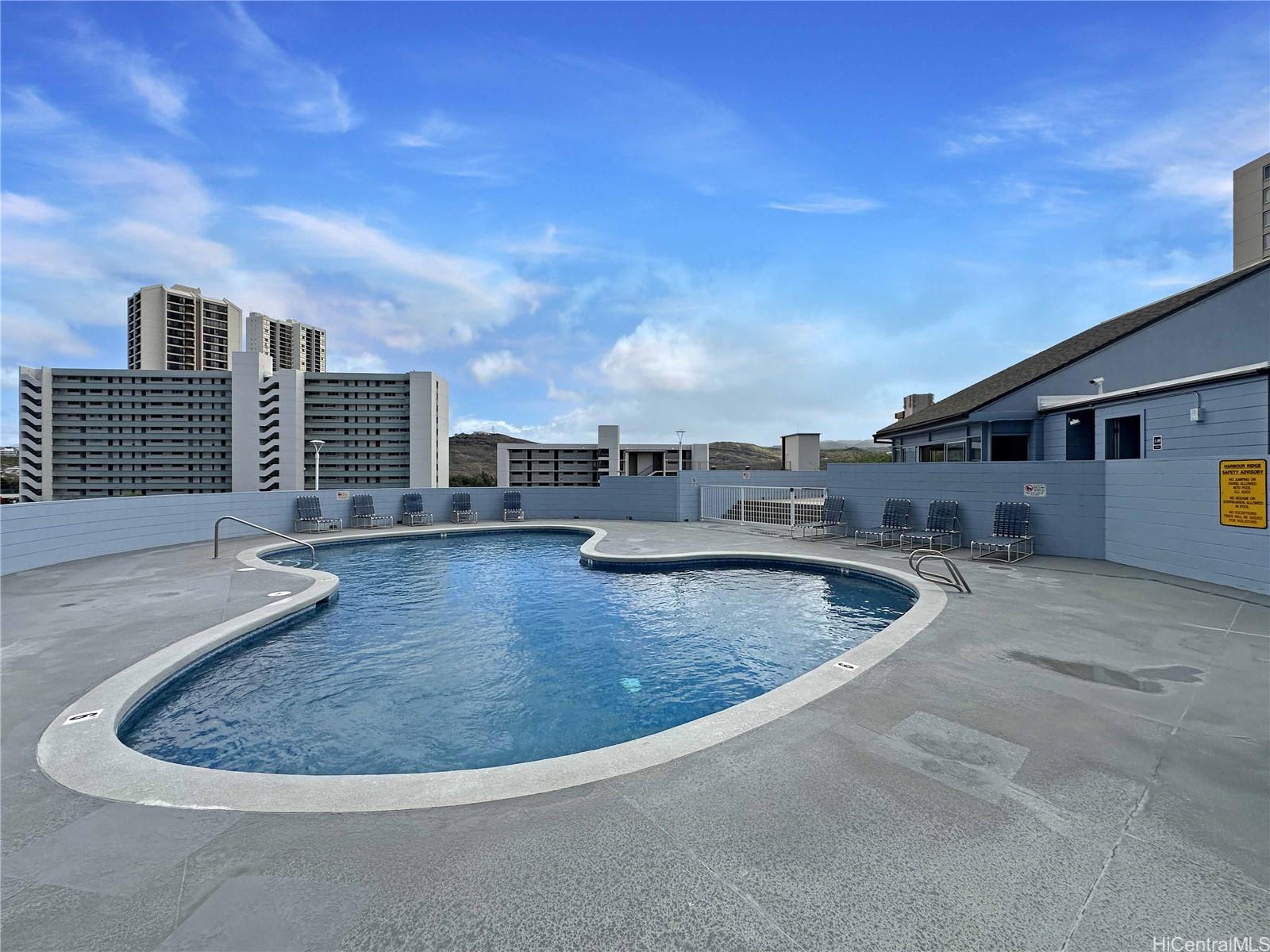 3045 Ala Napuaa Place, Unit 1814 Honolulu, HI 96818 - Photo 12 of 16 a view of a swimming pool with a yard