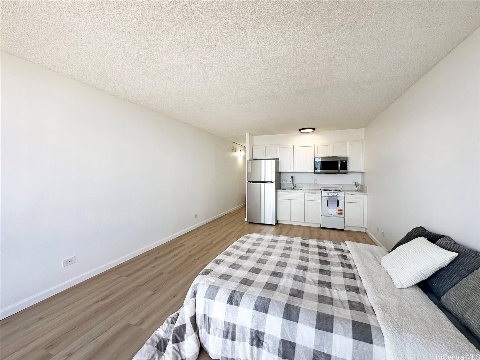 3045 Ala Napuaa Place, Unit 1814 Honolulu, HI 96818 - Photo 6 of 16 a kitchen with a stove top oven and cabinets