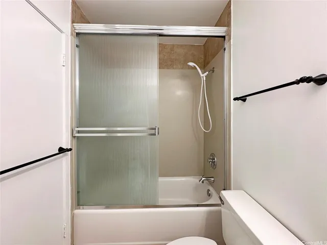 a bathroom with a shower and a bath tub