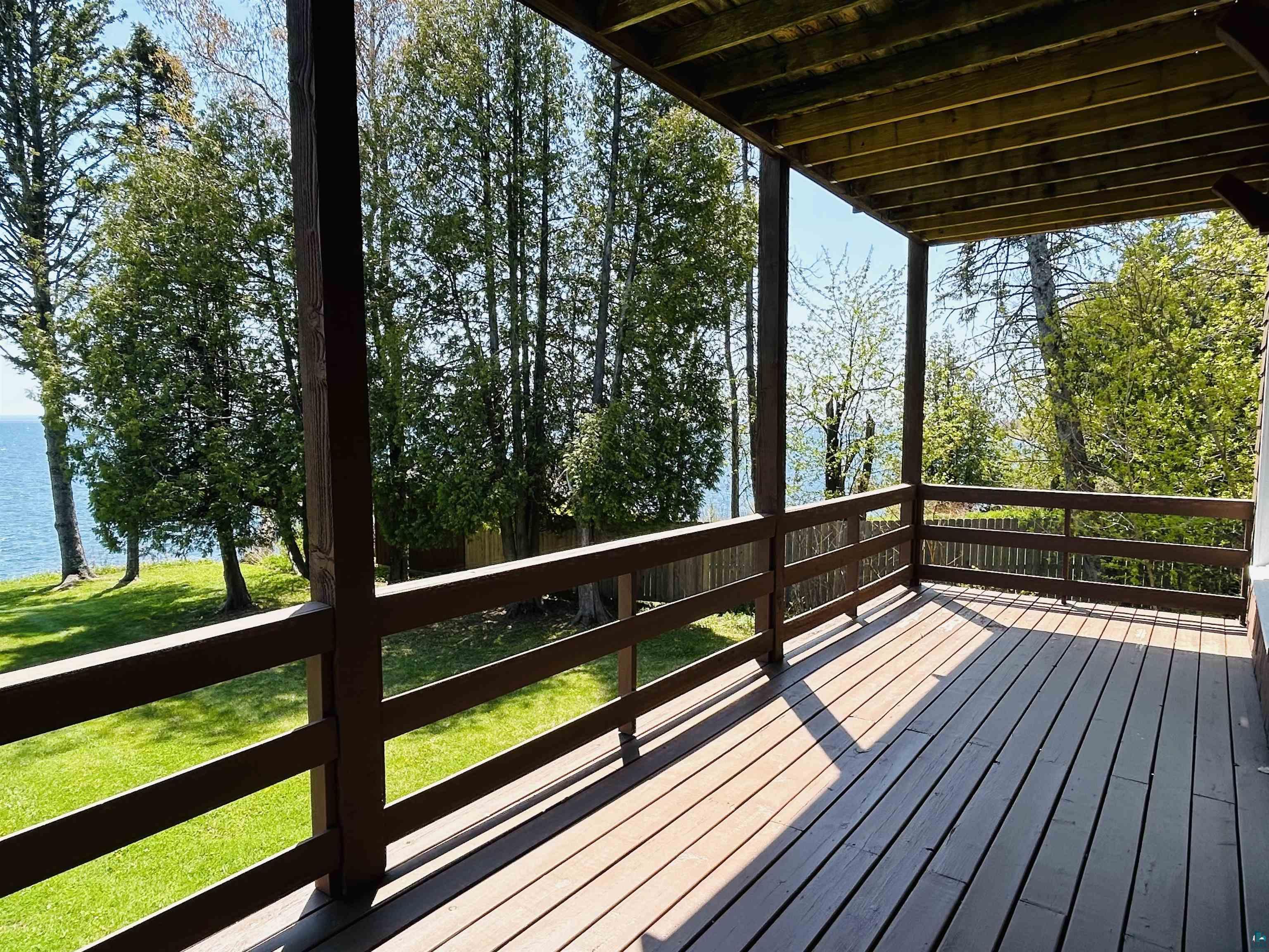 5090 London Road, Unit 1 Duluth, MN 55804 - Photo 35 of 54 Spacious outdoor deck with a wooden railing and a solid wood plank surface