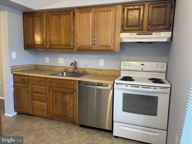 a kitchen with stainless steel appliances granite countertop a stove and a sink