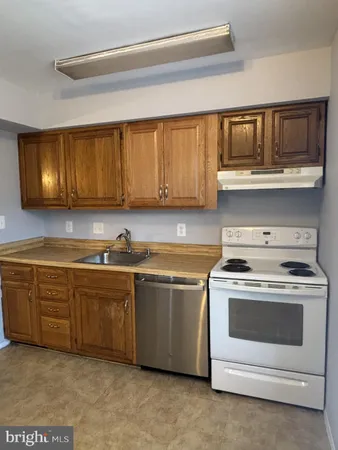 a view of kitchen with furniture and refrigerator