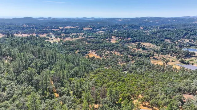 an aerial view of residential house and green space