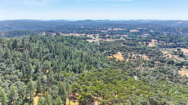 an aerial view of residential house and green space