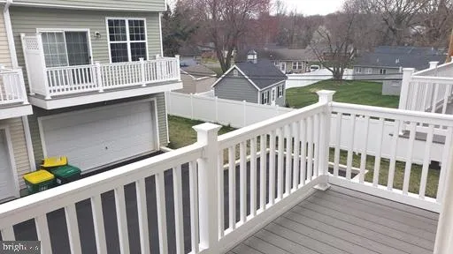 a view of a house with wooden deck and furniture