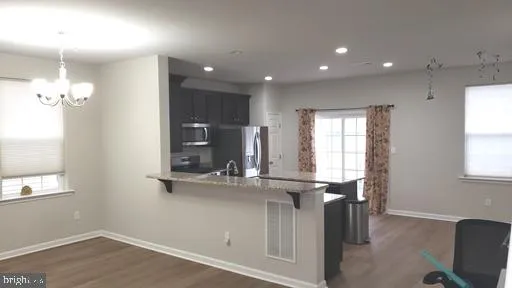a view of kitchen with kitchen island sink stove and microwave