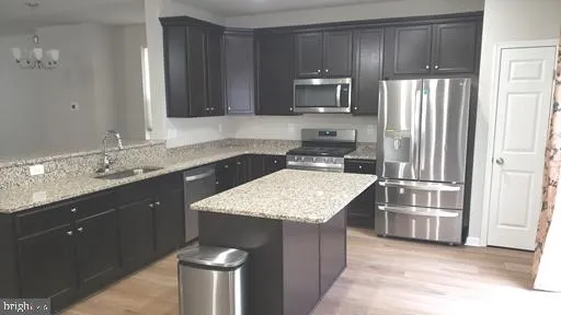 a kitchen with a sink stove and microwave
