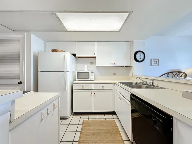 a view of a dining room with furniture and a kitchen