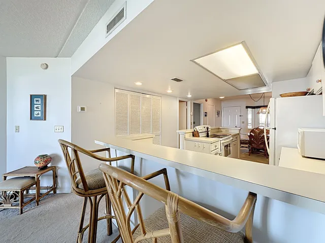 a living room with furniture a window and a bookshelf