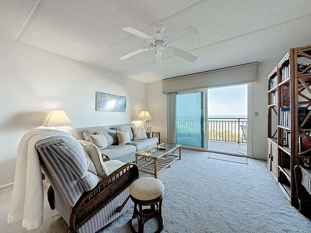 a living room with furniture a lamp and a window