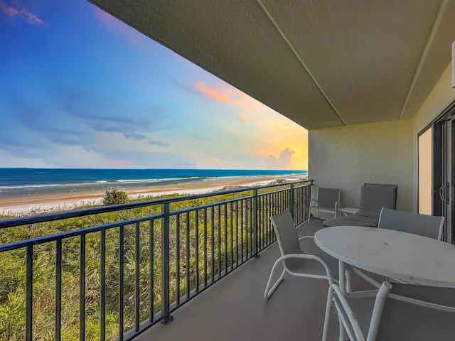 a view of a chairs and table in patio
